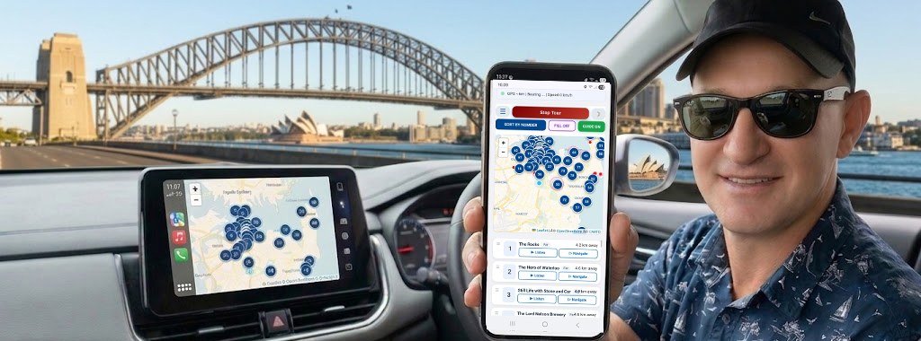 Sydney audio guide running on a phone and on the car screen, Harbour Bridge behind